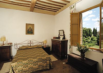 A bedroom of Villa Ballati in the park of Castello di Grotti near Siena